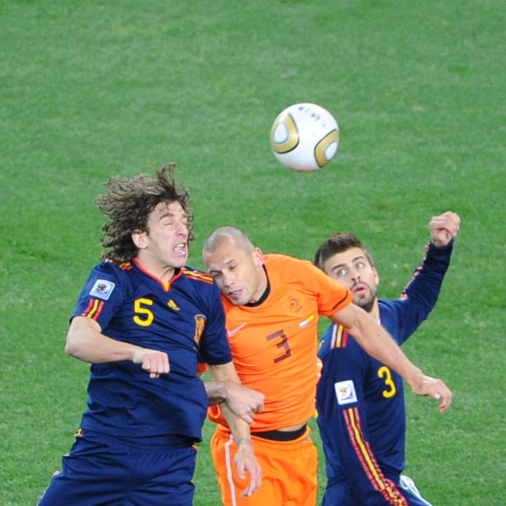Spain's defender Carles Puyol (L) heads
